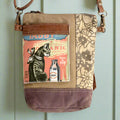 Sustainable shoulder bag with tabby cat illustration made from upcycled canvas and leather.