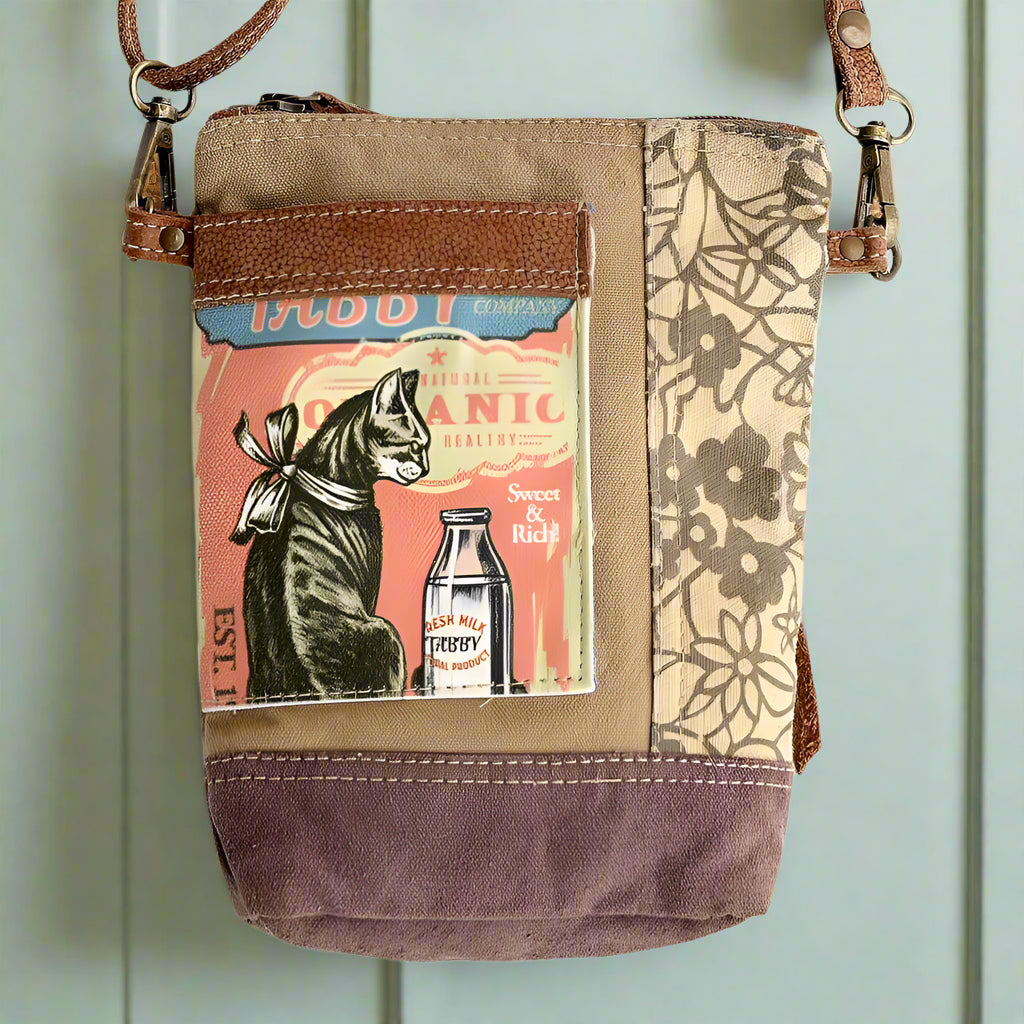 Sustainable shoulder bag with tabby cat illustration made from upcycled canvas and leather.